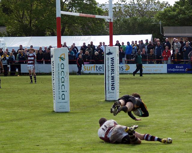 Webb dives over.jpg - Webb dives over. Photo by John Beach.